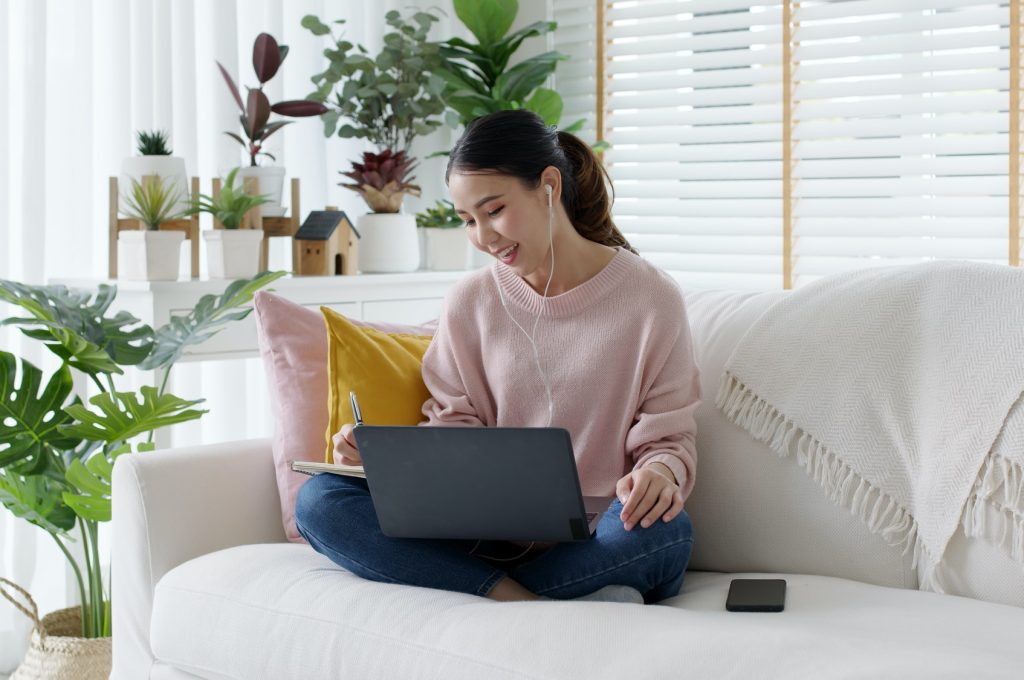 cozy-relax-young-attractive-asian-female-employee-wear-earphone-listen-to-digital-online-course